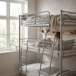 Metal bunk bed with safety rails, modern design, child reading in bright bedroom
