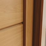 Sliding door detail of Genius wardrobe in cinnamon oak, elegant and durable finish